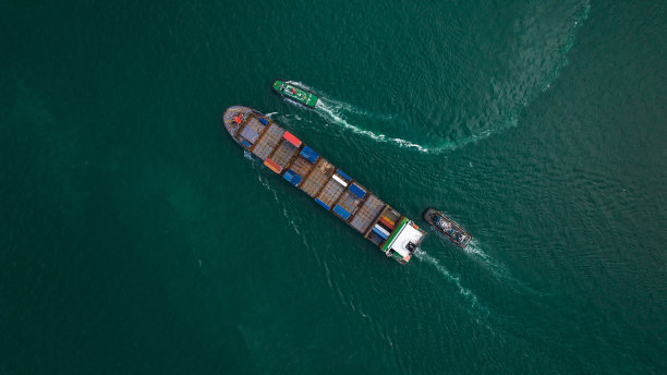 货运集装箱船在海上航行，进出口货物并将产品分销给世界各地的经销商和消费者，通过集装箱船运输业务服务。4 k的视频图片下载