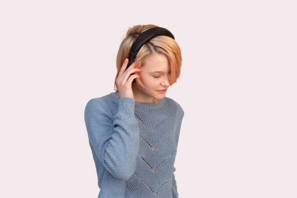 戴着耳机的少女被隔离在浅色背景上图片下载