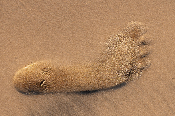 沙滩上的人类脚印特写图片下载