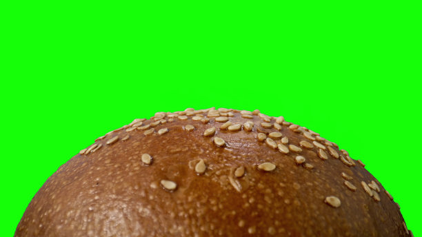 绿色背景下的美味汉堡。图片下载