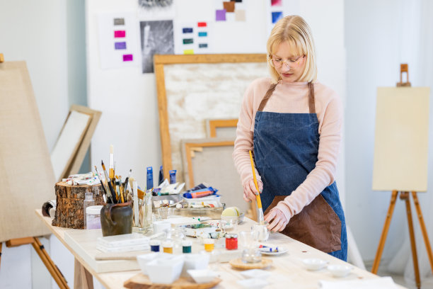 年轻的艺术家正在为绘画混合和准备颜料图片下载