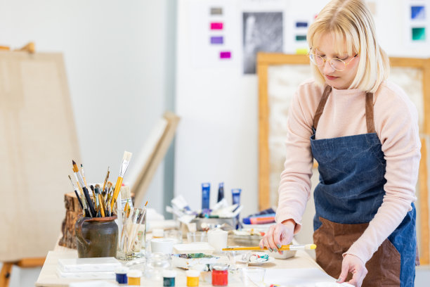 年轻艺术家在她的工作室工作图片下载