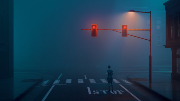 一名女子晚上在城市的十字路口停车等红灯图片下载