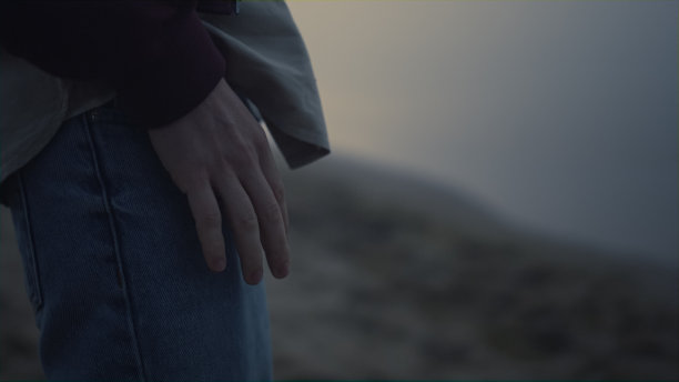 面目全非的男人在腿上敲手指。男人把手放在牛仔裤口袋上图片下载