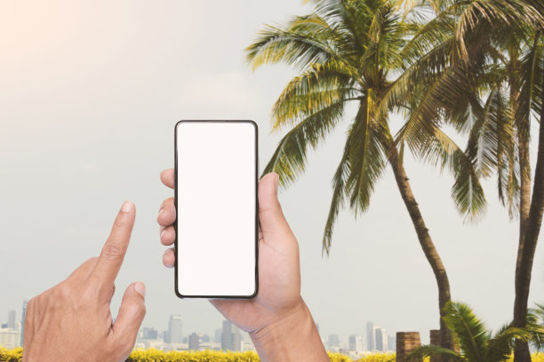 旅行者的手正在搜索目的地，如酒店、餐厅或咖啡馆，或预订机票。为额外的用户界面空出手机屏幕。图片下载