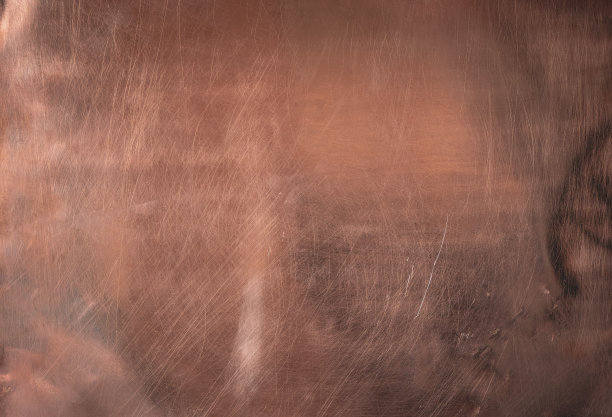 铜的背景。铜表。左自然采光。划痕。图片下载