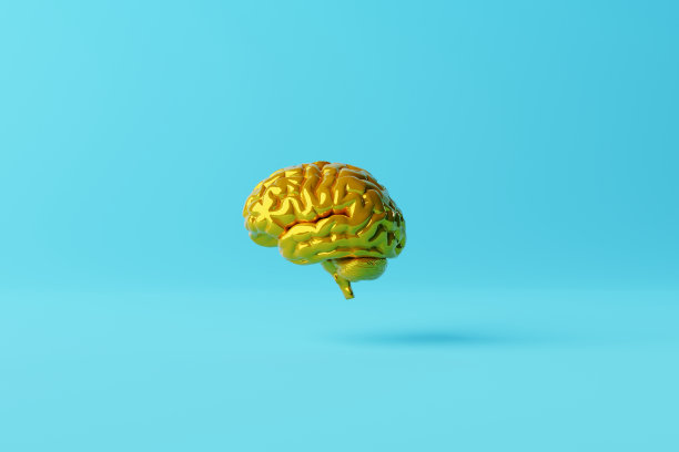 蓝色背景下的黄色大脑。图片下载