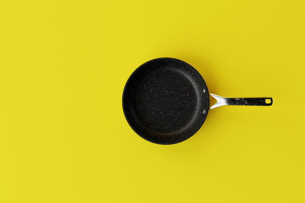 黑色平底锅，黄色底色。图片下载
