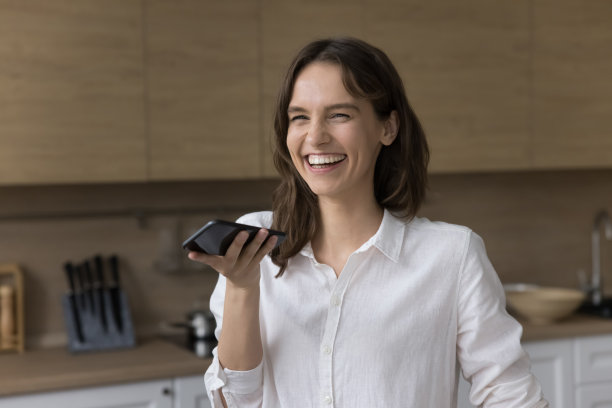 欢快兴奋的智能手机用户女孩使用语音虚拟助手应用程序图片下载