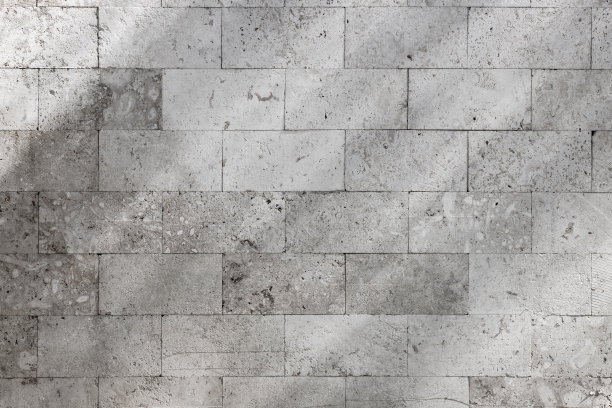 石墙上有阴影线条图案。背景照片纹理图片下载