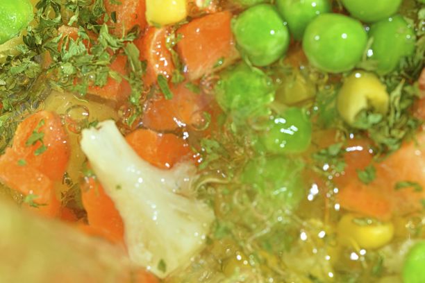 近距离观看蔬菜汤与胡萝卜，豌豆，花椰菜，玉米和欧芹。冷冻蔬菜汤的口感。冷冻蔬菜汤。冻汤蔬菜准备煮平设计，俯视图。宏观背景。水平的形象。模糊图片下载