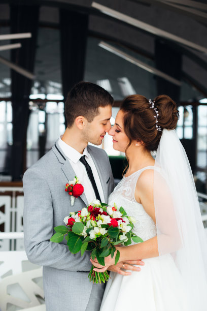 新婚夫妇在餐厅大厅接吻。新娘举行婚礼图片下载