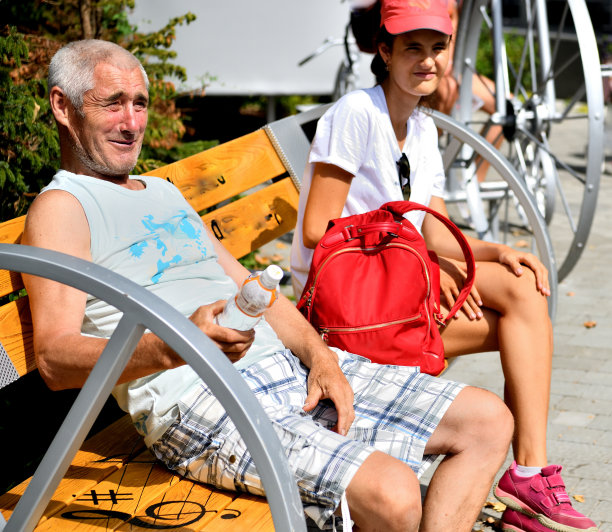 在一次旅行中，一家人坐在森林公园的长椅上休息图片下载