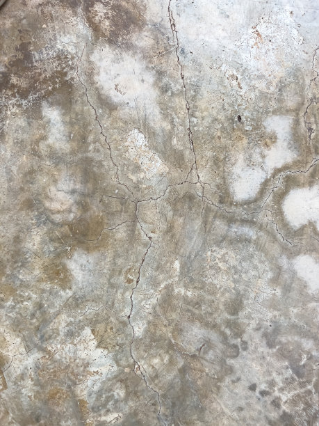 灰棕色混凝土地板背景，有裂缝和白色斑点图案。抽象的背景。图片下载
