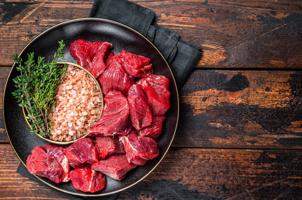 炖牛肉用的生瘦肉丁砂锅牛肉。木制背景。前视图。本空间图片下载