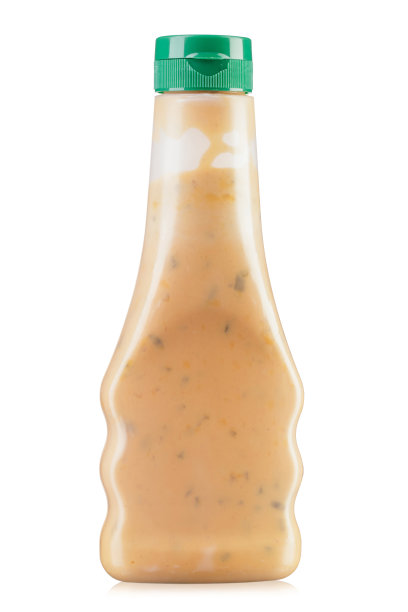 奶油酱在瓶子里。孤立在白色背景上。图片下载