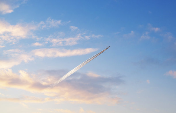 飞机在蓝色与云日落天空。图片下载