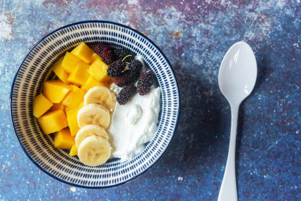 蓝底桑椹、芒果、香蕉酸奶碗。图片下载