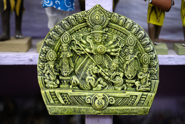 美丽的手工雕刻的女神杜尔迦展示在一个商店出售模糊的背景。印度艺术和手工艺品。图片下载