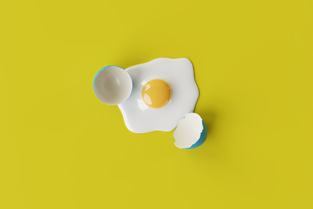 黄色背景上的破鸡蛋。图片下载