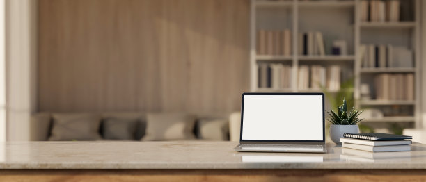 桌面与笔记本电脑模型和复制空间模糊舒适的客厅背景。图片下载
