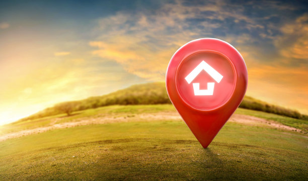 房屋符号与定位针图标在地球上和绿色的草在房地产销售或物业投资的概念。图片下载