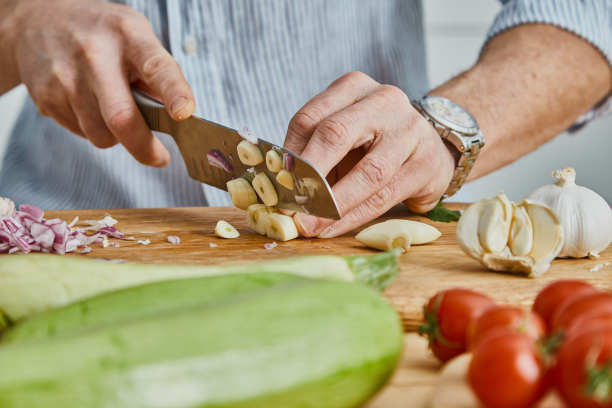 健康的素食食品准备，男子切大蒜图片下载