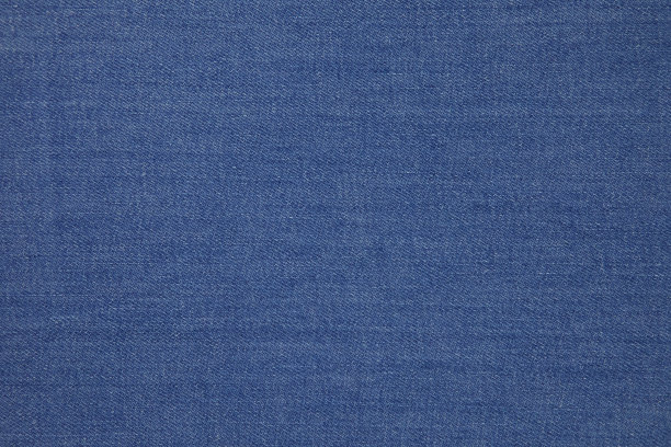 蓝色牛仔裤面料背景纹理。蓝色牛仔裤面料布纺织材料。图片下载