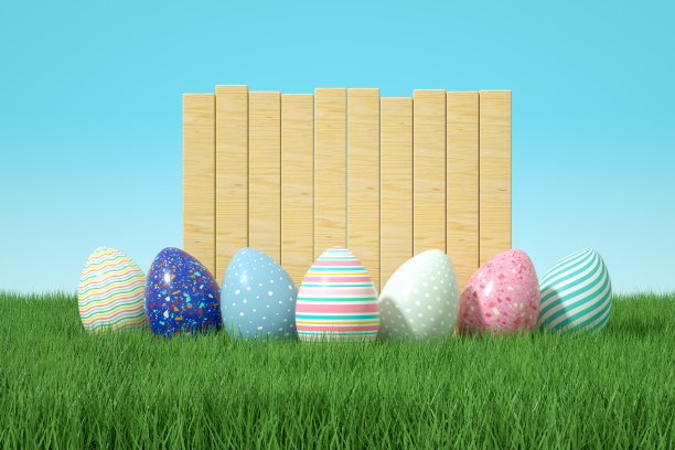 草地上的复活节彩蛋和空的木招牌图片下载