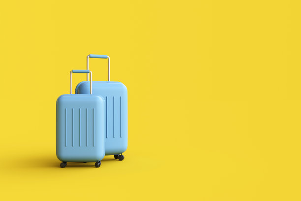 黄色背景旅行箱。图片下载