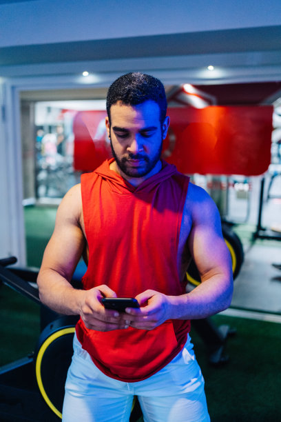 年轻的夫妇正在健身房锻炼。迷人的女人和英俊的肌肉男子正在轻现代健身房训练。做壶铃平板支撑。举重俯卧撑。图片下载