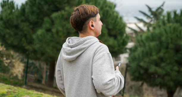 一个年轻英俊的商人在城里玩手机的镜头图片下载