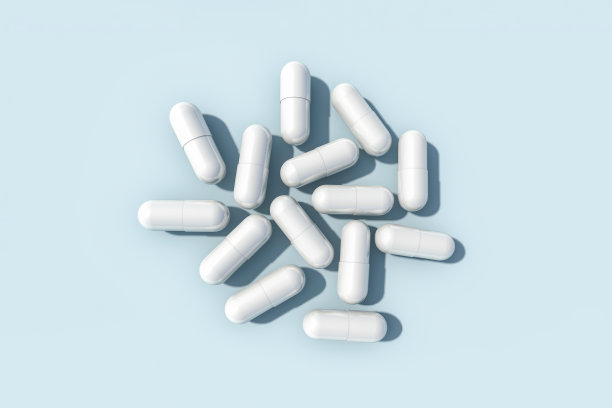 蓝色底色的白色药丸胶囊。模拟。平铺，复制空间。三维渲染图片下载