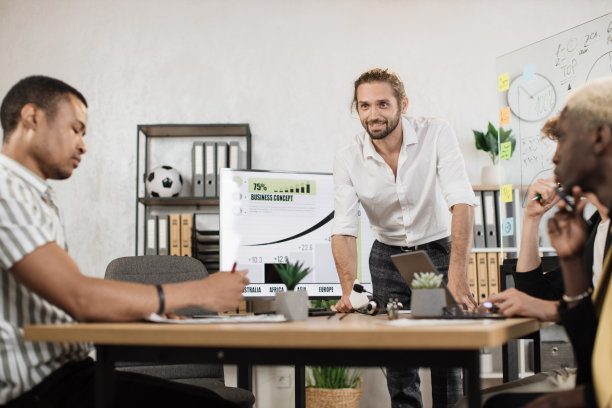 多民族公司员工坐在现代化设备的办公桌前，准备财务报告图片下载