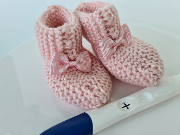 验孕棒和小婴儿拖鞋特写图片下载