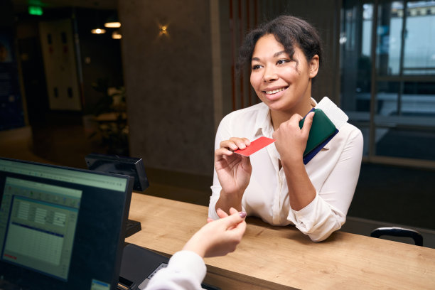 微笑快乐的女游客从前台领取钥匙卡图片下载