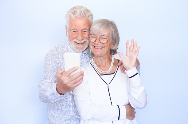 视频通话概念。快乐的老夫妻一起笑着用智能手机视频聊天在线交流，男人和女人表达幸福和积极的情绪图片下载
