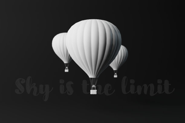白色的气球在黑暗的背景与天空是限制铭文。图片下载