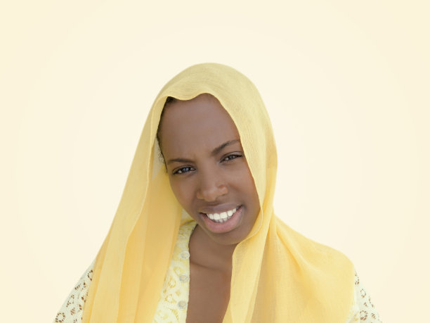 美丽的女孩戴着黄色面纱，18岁，黄米色背景，照片图片下载