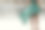一个穿着夏装的年轻女子赤脚走过潮湿的广场。图片下载