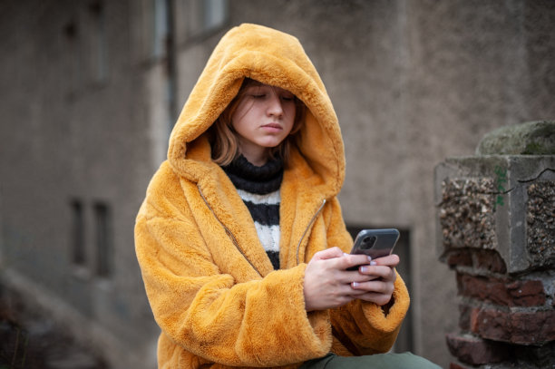 年轻漂亮的少女社交媒体影响力使用她的智能手机图片下载