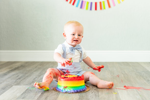 一个小男孩一岁的生日蛋糕，他觉得恶心，非常不确定，有趣的可爱的孩子图片下载