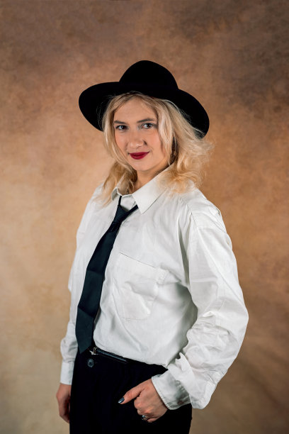 漂亮的时尚模特在一个朴素的背景上穿着宽松的裤装。女人的时尚图片下载