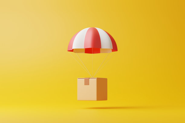 棕色包裹纸板箱，黄色背景上有红白降落伞图片下载