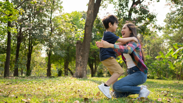 快乐的亚洲母亲与她的儿子在户外玩耍-家庭和爱的概念。庆祝母亲节。图片下载