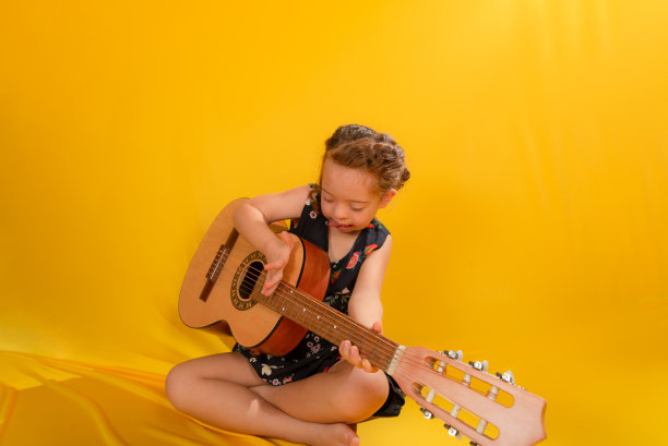 有才华的红头发女孩弹吉他和唱歌。图片下载