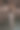 一张海滩照片，一个美丽的性感的年轻女子，黑色长发，穿着裙子，在海滩上的巨石旁摆姿势。图片下载