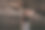 一张海滩照片，一个美丽的性感的年轻女子，黑色长发，穿着裙子，在海滩上的巨石旁摆姿势。图片下载