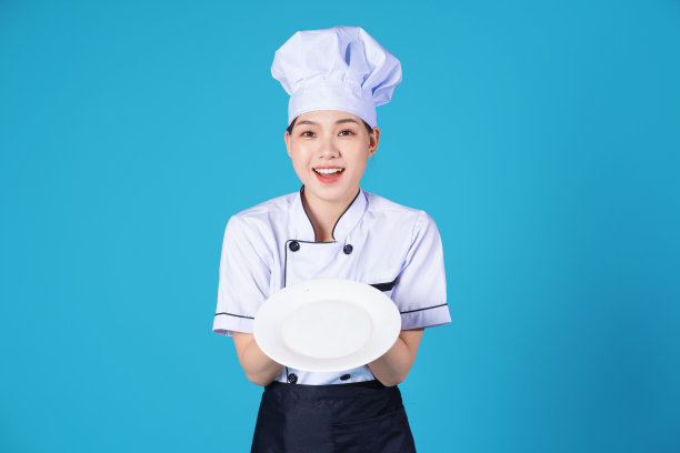 年轻的亚洲女厨师的背景肖像图片下载