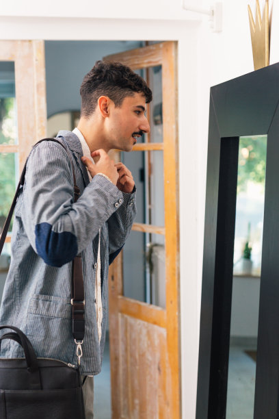 年轻的成年男子准备工作。照镜子图片下载